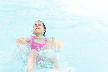 Fototapeta na wymiar Beautiful little girl sunning at the pool