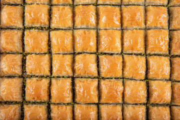 Traditional Turkish Pastry Dessert pistachio Baklava. Baklava shop. Turkish pistachio and yufka dessert, pistachio baklava on a tray.