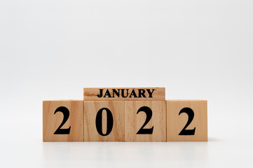 January 2022 written on wooden blocks isolated on white background with copy space