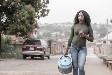 nigerian lady going to fill her gas cylinder unhappy