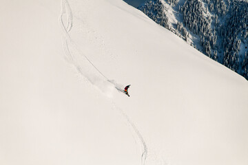 amazing view of mountain slope and skier sliding down on it. Freeride skiing concept