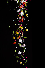 Sprinkles falling on a dark background