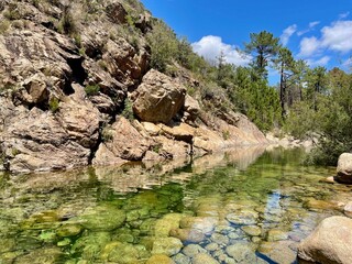 River Solenzara with clear, emerald-green water at the foot of Bavella peaks in Southern Corsica, France.