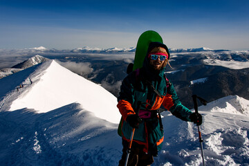 Fototapeta na wymiar man with ski equipment stands against the backdrop of beautiful winter mountain landscape