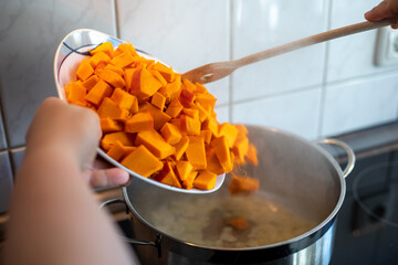 Cubes of pumpkin on cutting board