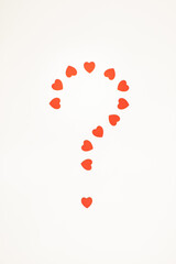 Question mark made of red heart shapes on white background.  Valentine's Day or Love minimal concept. Flat lay.