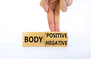 Body positive or negative symbol. Psychologist turns cubes, changes words body negative to body positive. Beautiful white background, copy space. Psychological, body positive or negative concept.