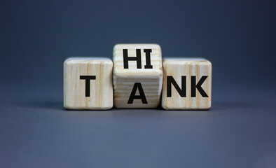 Think tank symbol. Businessman turns a wooden cube and changes the word tank to think. Beautiful...