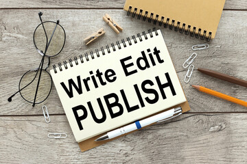 WRITE EDIT PUBLISH. notebook on a wooden table