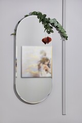 Mirror with branch and reflection of picture