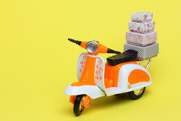 Toy scooter delivering goods. Delivery service and  online order shopping  concept