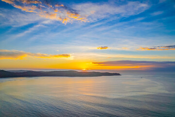 Fototapeta na wymiar Sunrise seascape with a mix of high and medium clouds