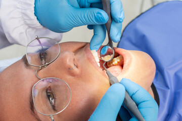 Young woman being examined by the dentist at the dental clinic. Concept of healthy teeth and medicine