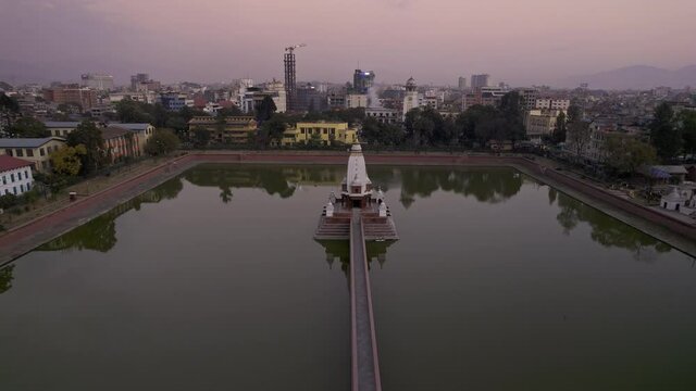 Flying over the Rani Pokhari pond in Kathmandu Nepal at dusk.