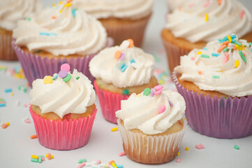 cupcakes with pink and pastel frosting and sprinkles