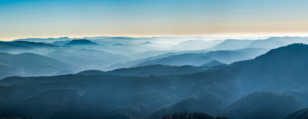  White snow and blue sky. Panoramic view of the silhouettes of the mountains.