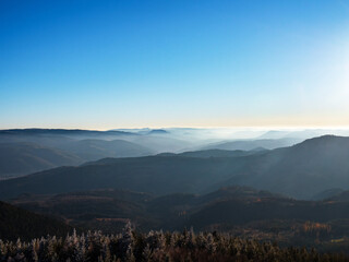 Fototapeta na wymiar White snow and blue sky. Panoramic view of the silhouettes of the mountains.