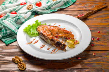 salmon fillet cooked on the grill on wooden table