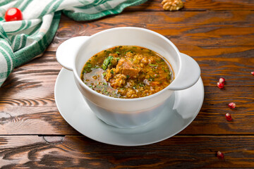 soup kharcho on bowl on wooden table