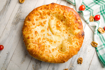 khachapuri with cheese, megrelian khachapuri, georgian cuisine on white wooden table  top view
