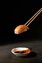 Selbstklebende Fototapeten shrimp sushi with chopsticks © kiboka
