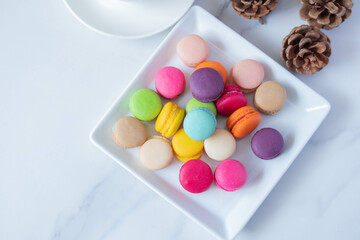 colorful macarons in white plate