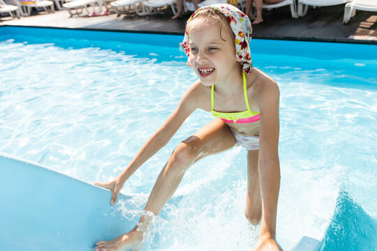 Swimming - little girl playing in blue water