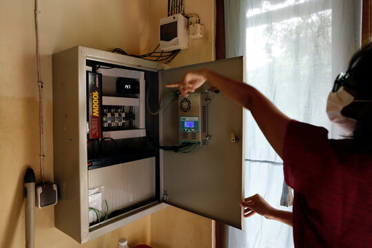 Hiyashinta Klise shows a electricity panel which received electric supply from the solar panel in Bekasi