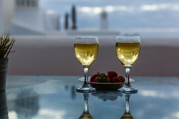 two glasses of champagne at rooftop restaurant with view . luxury romantic dinner for couple.