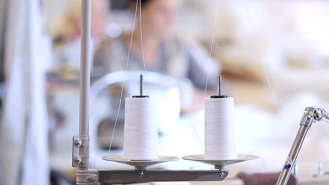 Sewing equipment at a sewing factory. A skein of thread close-up. Spools of thread at a sewing factory.