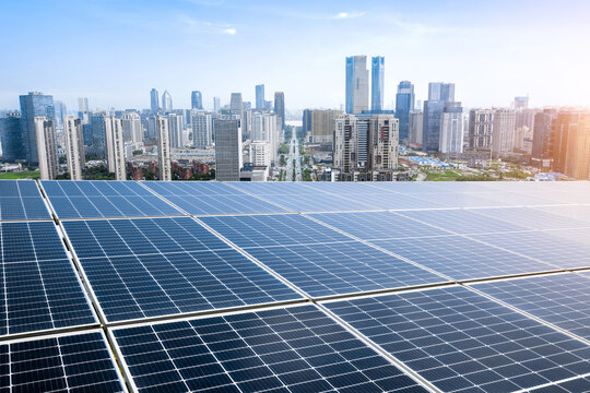 Photovoltaic panels in front of city background