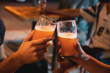 person holding a glass of beer