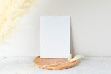 Blank paper cards, Greeting card Mockup with pampas grass on a wooden plate, beige background,...