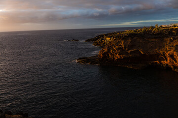Panoramic view of the Illuminated Las Americas at night against the colorful sunset sky with lights on the horizon on Tenerife island, Spain