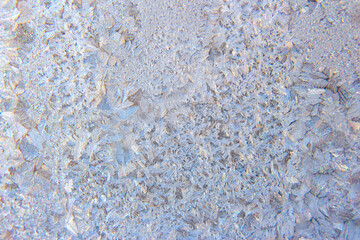 frosty patterns on the window glass closeup. natural textures and backgrounds. ice patterns on frozen