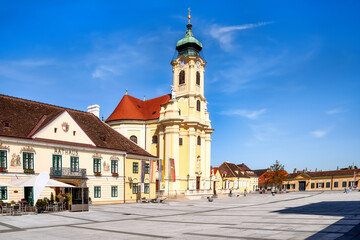 Fototapeta na wymiar Old town hall and Parish church on the Schloßplatz in Laxenburg, Austria - historical building