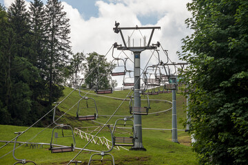 Selective blur on stopped ski lifts, not working in summer, in a ski resort, by slopes, in the...