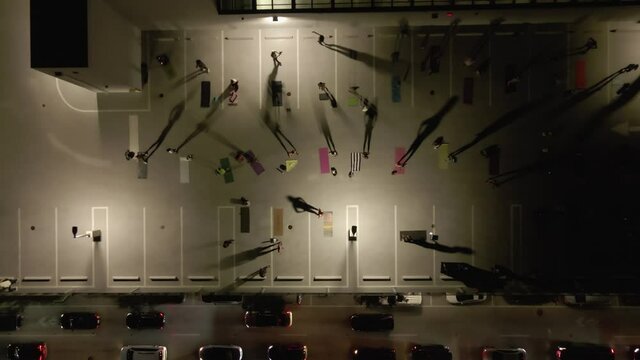 Rising night aerial of roof top exercise class in South Beach Miami