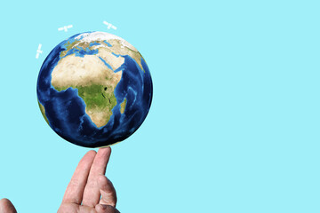 A man balancing a stylized 3D rendered illustration of planet earth with satellite  icons, internet telecommunication technology, data usage and metaverse.