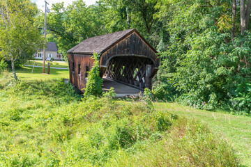 Wide view of the Baltimore covered bridge is an old wooden bridge located in Springfield Vermont...