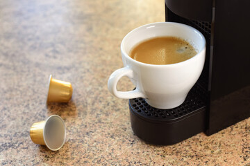 Cup of coffee and capsule coffee machine
