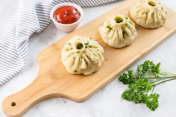 Traditional oriental food - manti with meat. The concept of Oriental cuisine.