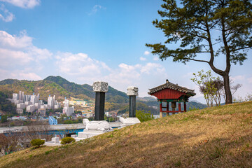 Oriental pagoda and turtle pillars on hill outlook with view of cityscape in the mountains in South Korea