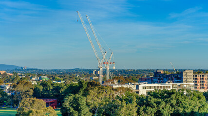 Melbourne, Australia, A suburban apartment development under construction with two large cranes...