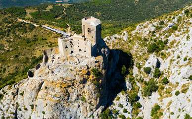 Picturesque rocky landscape overlooking medieval ruined castle Chateau de Queribus in summer, commune of Cucugnan, France