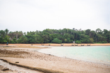 Sea coast with small fisherman boat on sand beach and tree background. nature landscape view island. ocean Thailand. tourism tropical outdoor vacation  travel summer holidays concept.