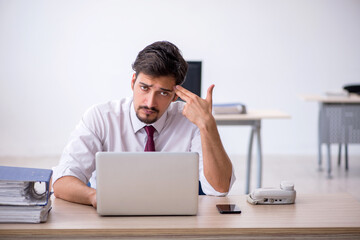 Young male employee working in the office