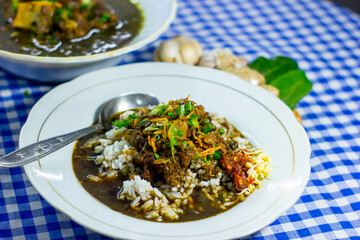 Kediri, Indonesia - January, 6, 2022: Rawon Buntut Sapi Indonesian Beef Soup The Black Keluak Nut as The Main Seasoning