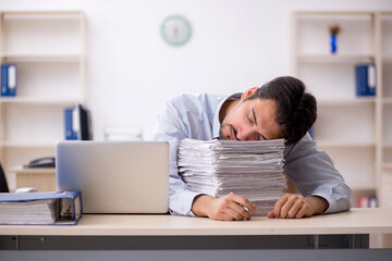 Young male employee working in the office