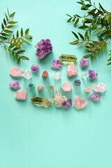 minerals and green leaves on green background. Stones for Crystal Ritual, esoteric spiritual practice, spa, relax. modern magic. reiki therapy, life balance concept. top view. copy space